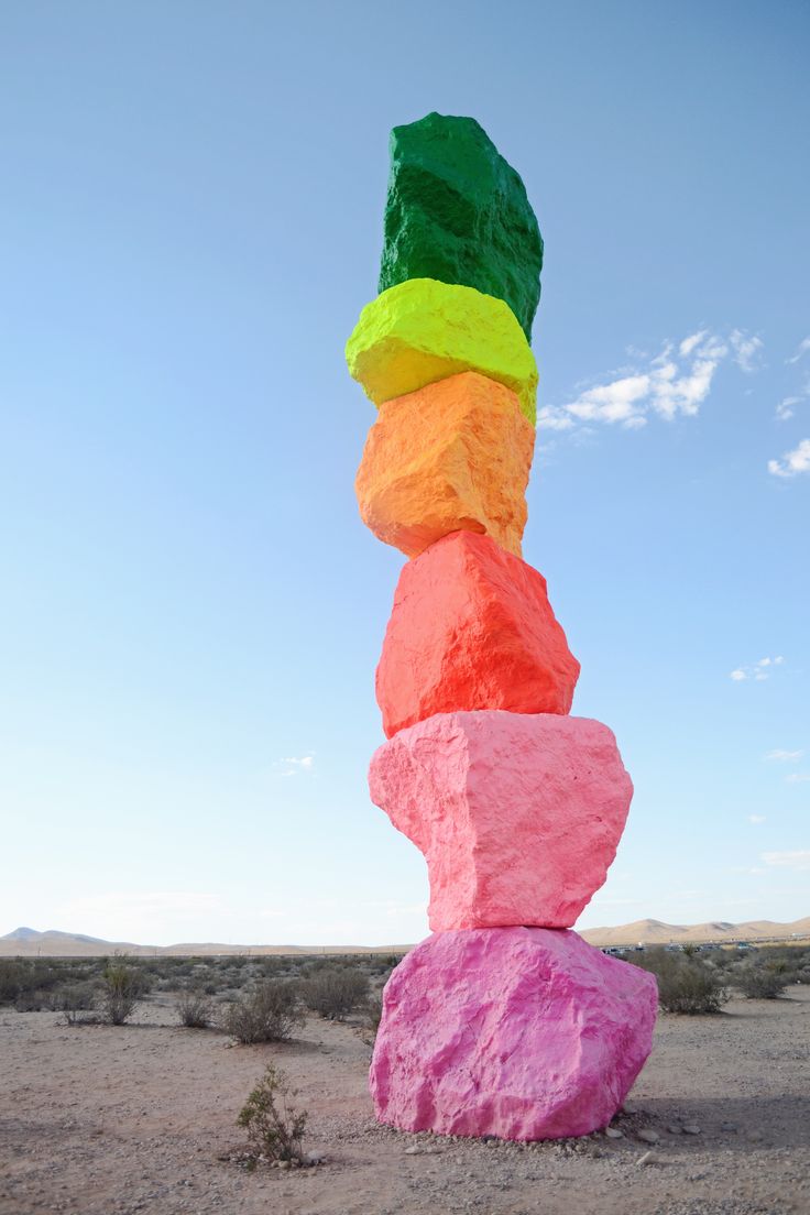 a stack of colorful rocks in the desert