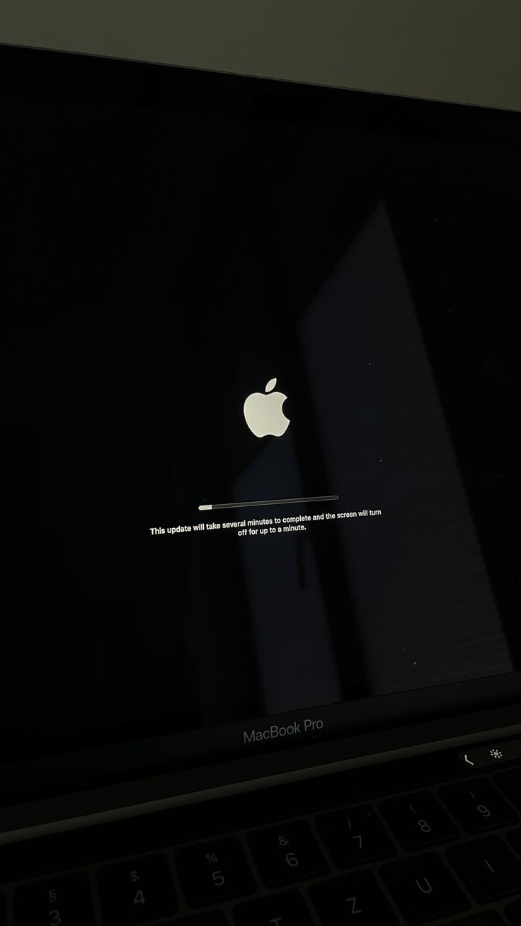 an apple logo is displayed on the screen of a laptop computer, in this image