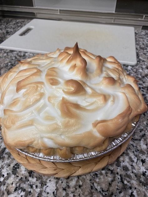 a pie sitting on top of a counter covered in frosting