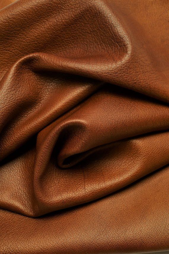 a brown leather textured up close to the surface