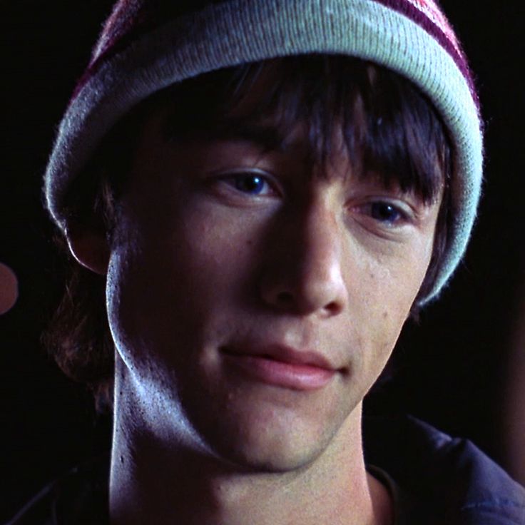 a young man wearing a beanie looking at the camera