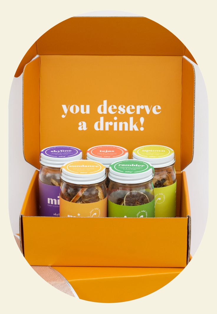 an orange box with six jars filled with different types of drinks and the words you deserves a drink