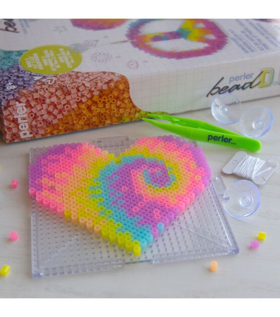 a heart shaped bead kit sitting on top of a table next to a box