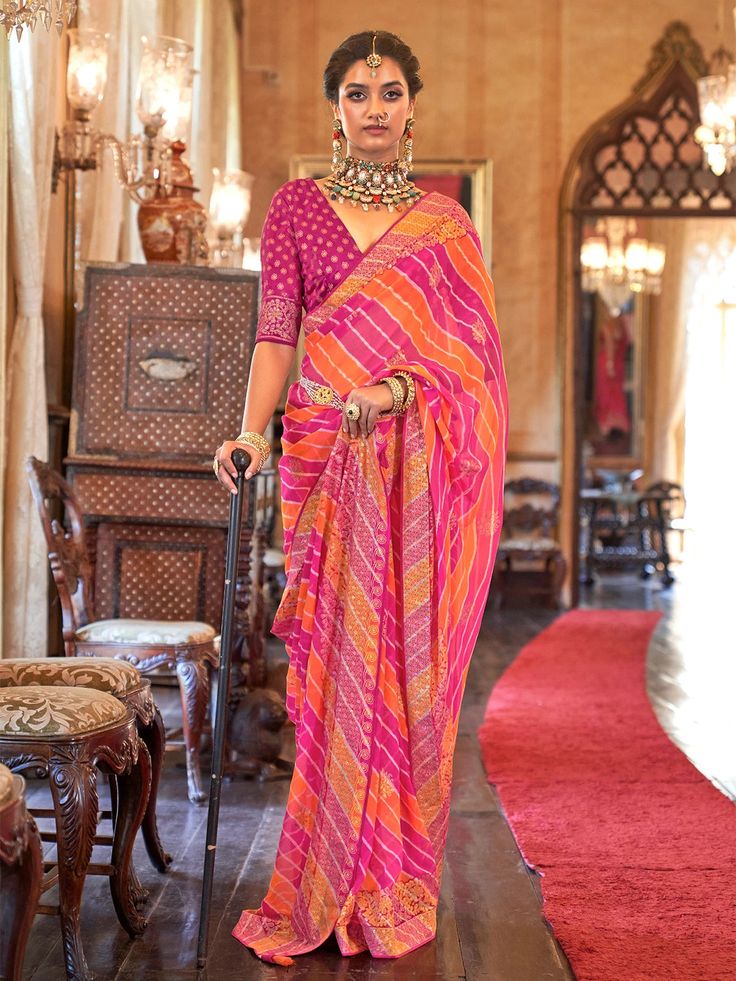 Daya Georgette Laheriya Printed Saree Soft easy to wear georgette fabric. Beautiful laheriya print . Comes with unstitch blouse fabric. This Daya Georgette Laheriya Printed Saree is perfect for special occasions. Its lightweight fabric is comfortable to wear all day and its vibrant print creates a unique look. The saree also features a trendy Laheriya print that elevates the look for a modern statement. Lehariya Saree, Wedding Sarees Online, Orange Saree, Utsav Fashion, Ghagra Choli, Latest Sarees, Georgette Saree, Georgette Fabric, Jodhpur