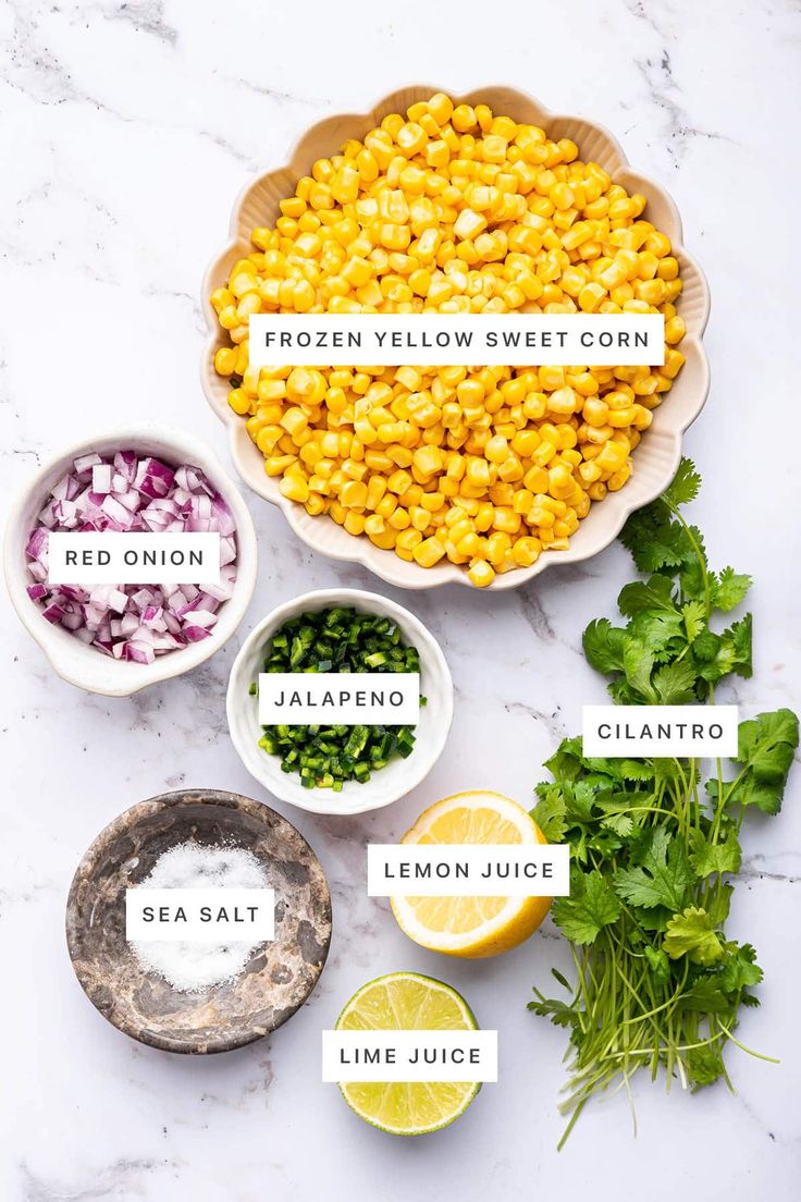 ingredients to make frozen corn salad in bowls on a marble counter top with text overlay