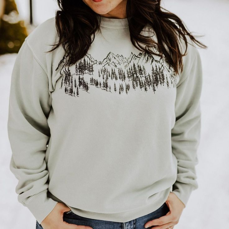 Mountain Sketch Unisex Pullover - SageThis item continues to be a top seller and is always flying off the shelves. Grab one for all your adventures. Model is wearing a size medium.80/20 cotton/polyester Body Length 27 28 29 30 Chest Width (Laid Flat) 20 22 23 1/2 25 1/2 Sleeve Length (From Center Back) 34 1/2 35 1/2 36 1/2 37 1/2 Mountain Sketch Unisex Pullover - Sage A Montana Scene Original Design. Printed in Montana. All designs are property of The Montana Scene. All rights reserved. Come vis Mountain Sketch, One For All, Sage Color, Autumn Night, Top Seller, Staple Pieces, Store Fronts, Original Design, Original Designs