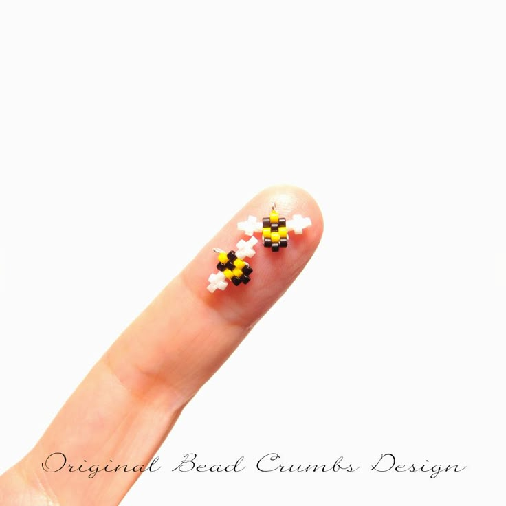 a person's finger with some tiny flowers on it, and the tip of their thumb