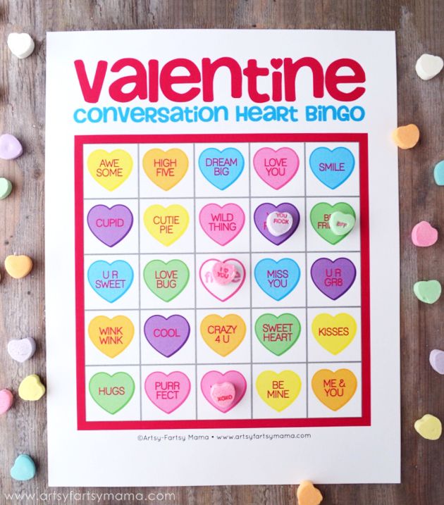 valentine's day conversation heart bingo game on a table with candy hearts around it