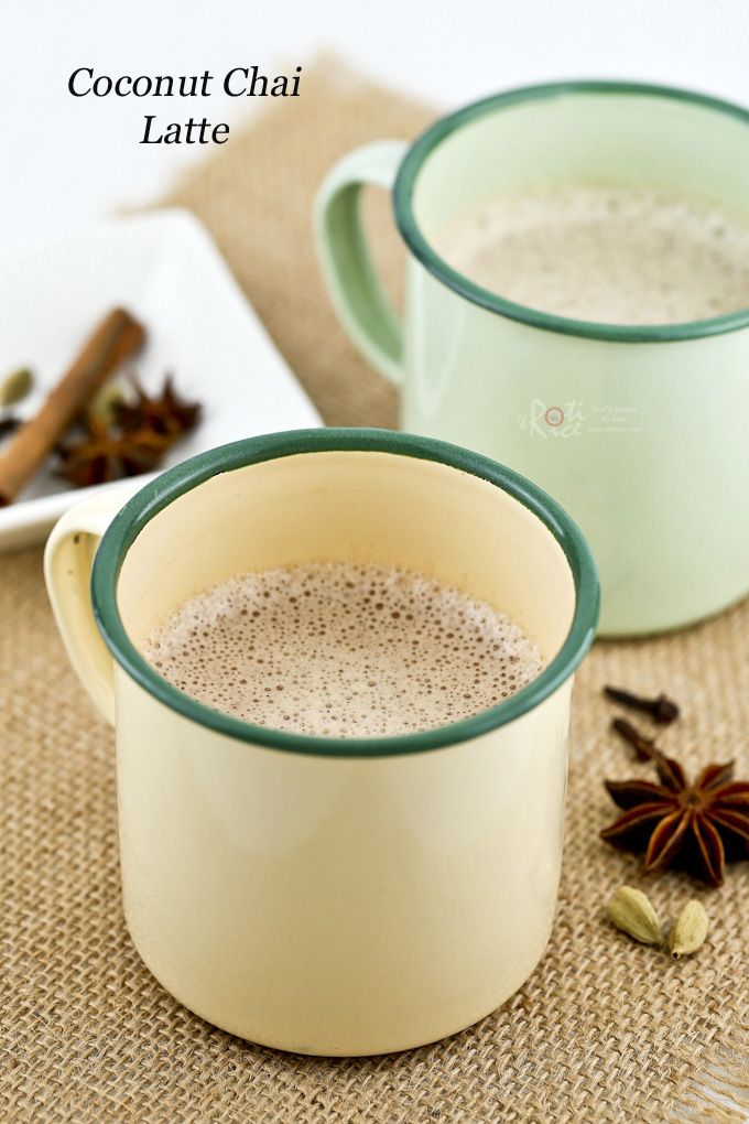 two mugs filled with cinnamon and anise on top of a burlly place mat