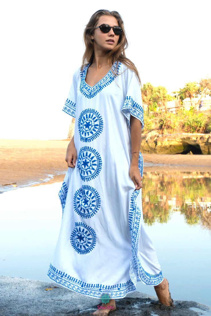 Step out in luxury with our Shu-Shi Embroidered Long Kaftan Dress. This unique maxi caftan dress features gorgeous embroidery, a flattering V-neck, and short sleeves. Perfect for resortwear or boho-chic style, this dress will be sure to make you the life of the party. Made from a lightweight fabric and detailed with intricate designs, this dress will be a luxurious addition to your wardrobe. Embroidered Kaftan For Beach Cover-up, Long Embroidered Kaftan For Beach Season, Long Embroidered Cover-up For Vacation, Embroidered Long Kaftan For Beach, Long Embroidered Kaftan For Beach, Embroidered Kaftan For Beach, Long Embroidered Beach Kaftan, Embroidered Beachwear Maxi Dress For Summer, Summer Embroidered Beachwear Maxi Dress