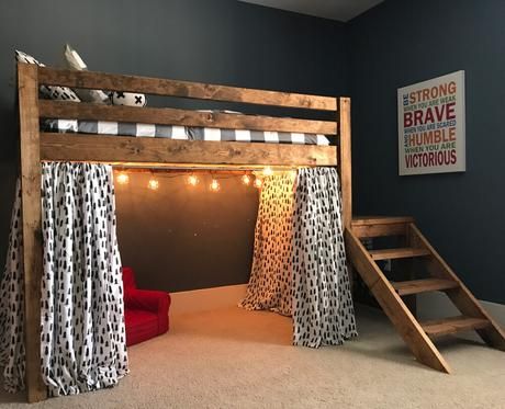 a loft bed with curtains and lights on the bottom is made from wood planks