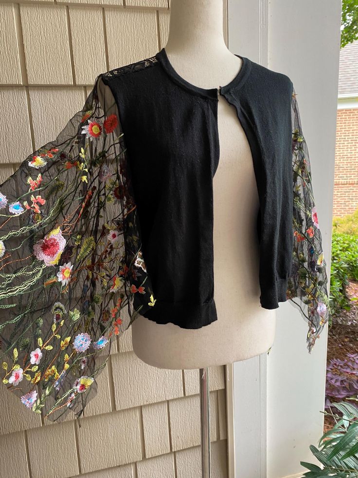 Ooak size medium black embellished cropped cardigan Size 8-10 Full refund if not satisfied Elegant Embroidered Spring Cardigan, Fitted Shrug With Lace Sleeves For Spring, Chic Long Sleeve Cardigan For Festival, Long Sleeve Summer Shrug For Party, Spring Bohemian Embroidered Cardigan, Fitted Bohemian Cardigan With Floral Embroidery, Chic One-size Spring Cardigan, Fitted Bohemian Embroidered Cardigan, Chic Shrug For Spring Layering