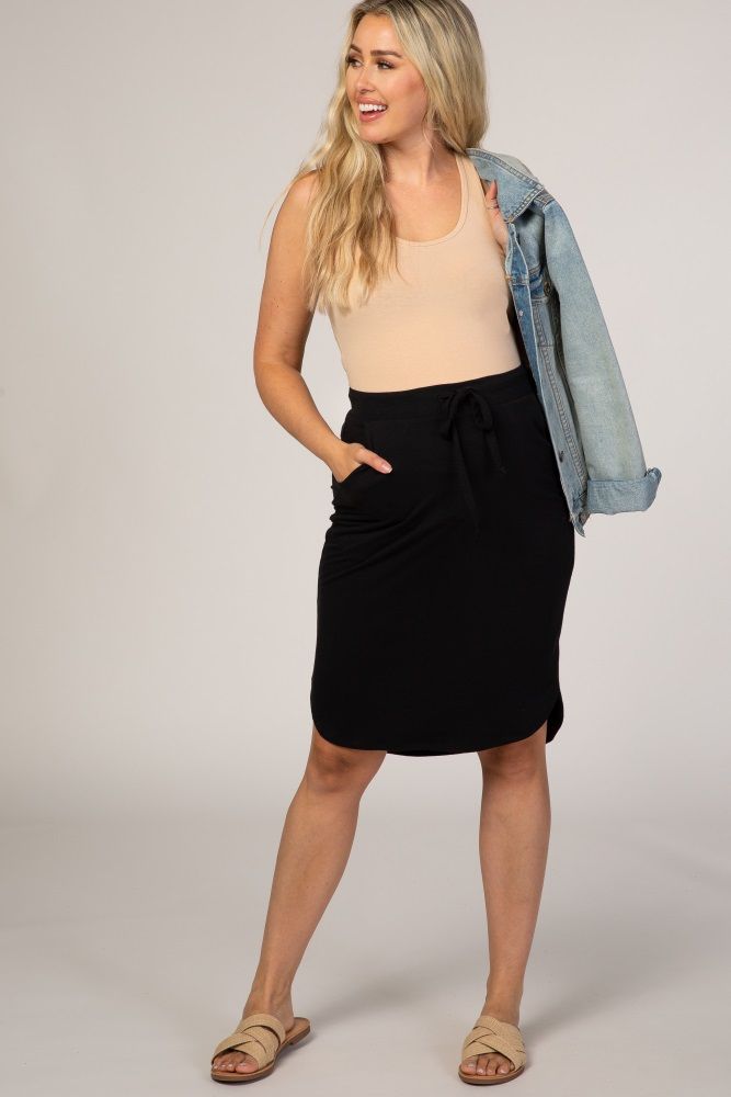 A basic skirt with side pockets and an elastic drawstring waist. The Black Maternity Skirt is perfectly bump-friendly! Casual Mini Cargo Skirt With Elastic Waistband, Relaxed Drawstring Skirt For Work, Relaxed Midi Skirt With Drawstring, Casual Skirt With Elastic Waistband For Everyday, Casual Everyday Skirt With Elastic Waistband, Casual Drawstring Skirt For Work, Drawstring Skirt For Day Out, Drawstring Mini Skirt For Day Out, Day Out Skirt With Drawstring