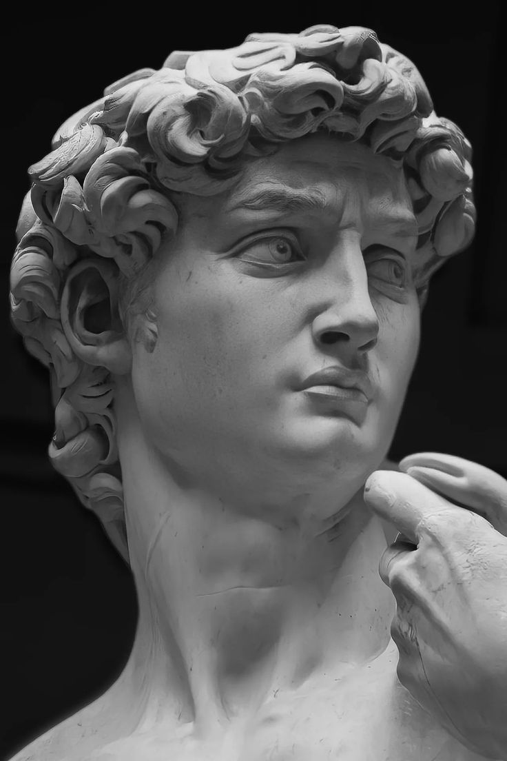 a close up of a statue of a man holding something in his hand and looking off to the side