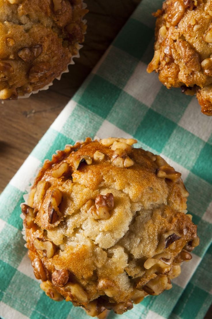 three muffins sitting on top of a green and white checkered napkin