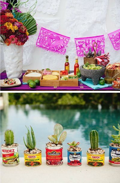 an assortment of food and drinks on a table next to a pool with flowers in it