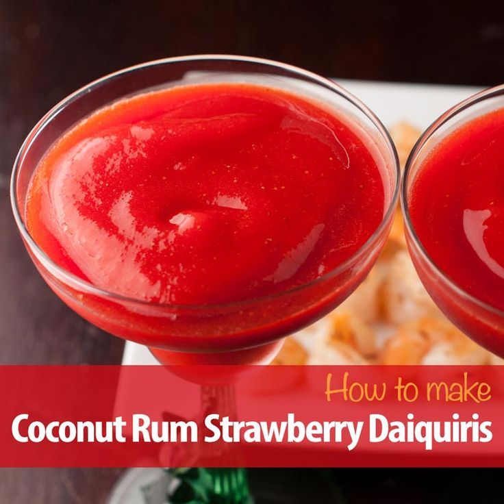 two glasses filled with red liquid sitting on top of a white plate