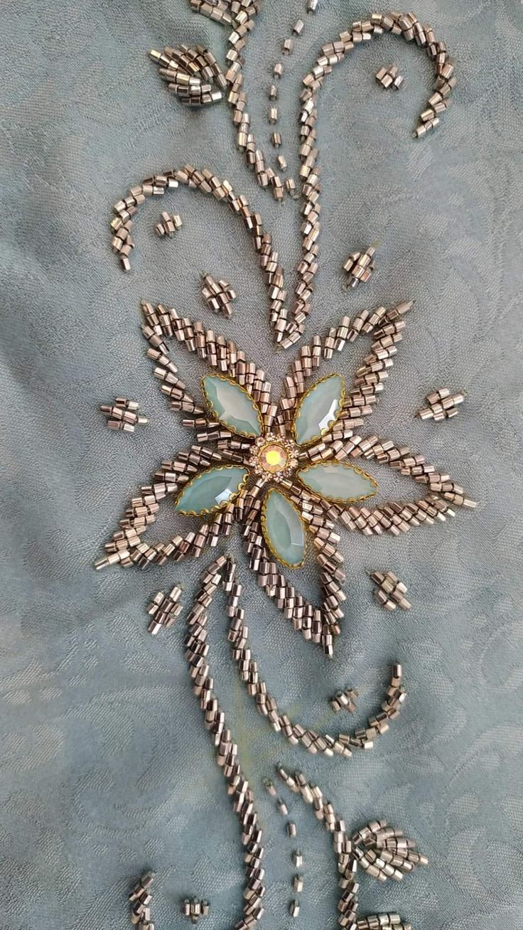 an intricately designed piece of cloth with beads on it