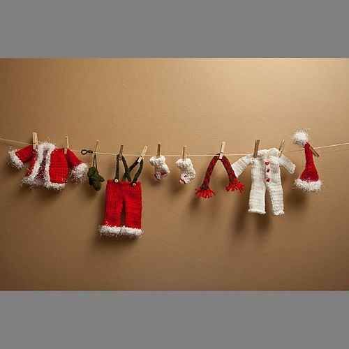 knitted christmas clothes hanging on a line