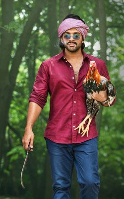 a man in a turban holding a rooster on a leash and walking through the woods