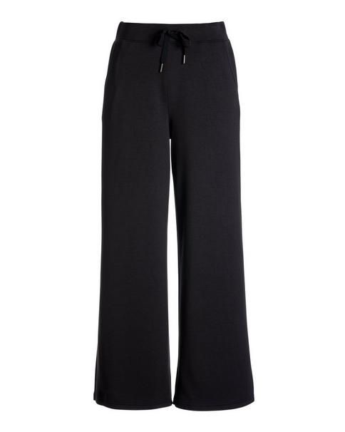 Crafted from a soft knit with a hint of stretch, our Luxe Lounge Drawstring Wide Leg Pant offers effortless polish in an easy, cropped length. Designed with an elastic drawstring waist and slash pockets, it pairs beautifully with our mock neck top for a refined-casual look. | Boston Proper - Black - Luxe Lounge Drawstring Wide Leg Pant - 2XS Fall Athleisure Wide Leg Pants For Lounging, Sporty Wide Leg Pants With Elastic Waistband For Fall, Chic Pull-on Sweatpants For Loungewear, Black Wide Leg Pull-on Pants For Loungewear, Black Pull-on Wide Leg Pants For Loungewear, Black Wide Leg Loungewear Pants, Wide Leg Lounge Pants, Luxe Lounge, Boston Proper