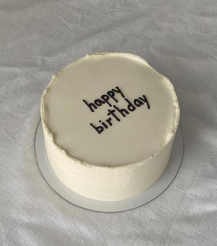 a birthday cake with the words happy birthday written in black on it's frosting