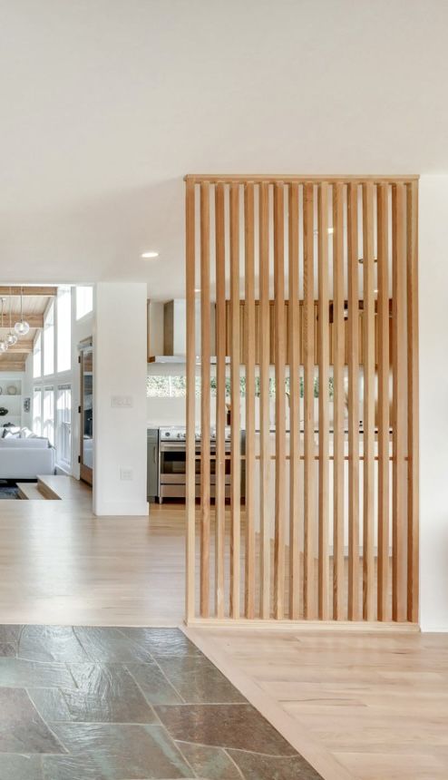 an open living room with wood slats on the wall