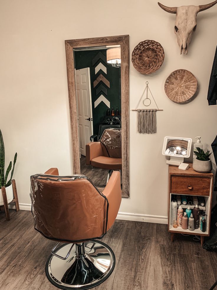 a room with a chair, mirror and deer head on the wall