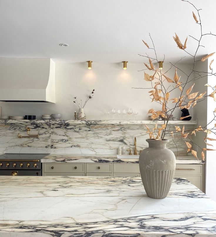 a vase sitting on top of a kitchen counter next to a stove and oventop