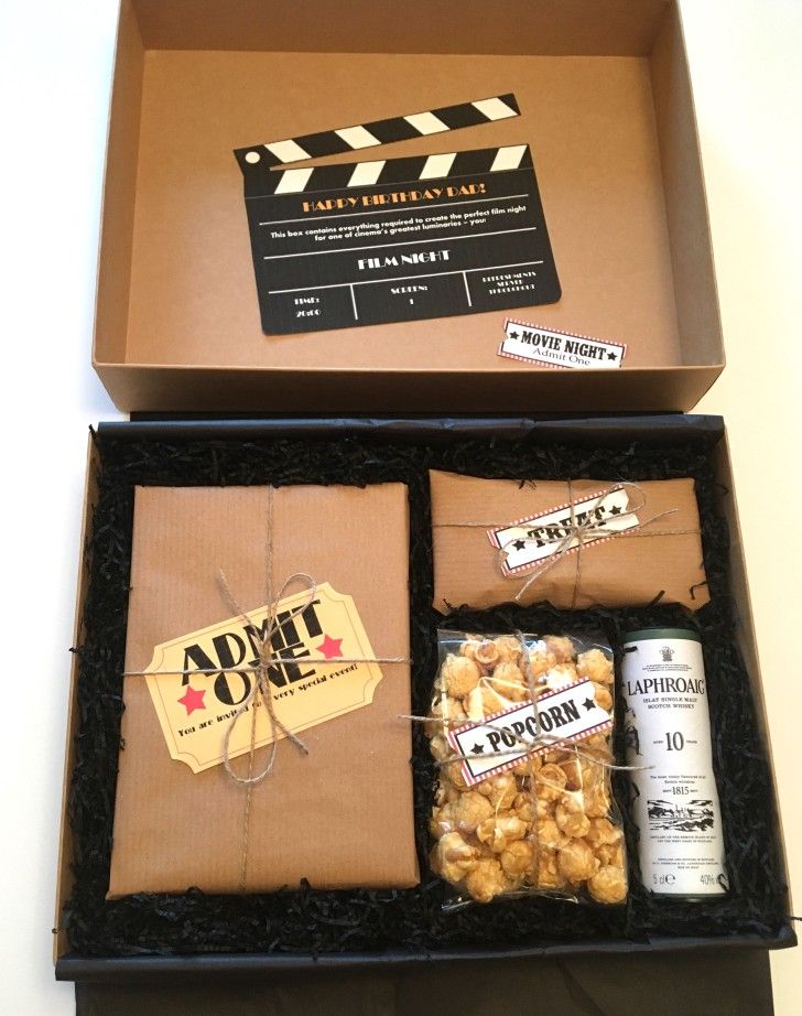 an open box containing popcorn and beer