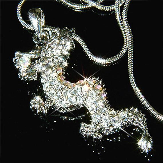 Want a personalized gift? -Add a Swarovski Crystal Birthstone charm here: https://www.etsy.com/listing/577441131PERFECT CHRISTMAS GIFT / CHINESE NEW YEAR GIFT FOR MAN / LADY !! You are getting a Classy, Magical DRAGON & CRYSTAL AB Spiritual BALL in the mouth Pendant with Swarovski crystals. It comes with a FREE 18" inches (45cm) silver finish snake necklace with lobster clasp.  The chain is removable, so you can put any chain, leather cord or rubber cord through the pendant. Pendant size is Christmas Crystal Necklace Gift, Silver Sparkling Rhinestone Necklace For Gift, Christmas Gift Crystal Necklace, Valentine's Day Gift Rhinestone Pendant Necklace, Dazzling Necklace For Gift, Dazzling Bling Rhinestone Necklace For Gift, Dazzling Rhinestone Bling Necklace For Gift, Dazzling Bling Necklace For Gift, Dazzling Bling Necklace Gift