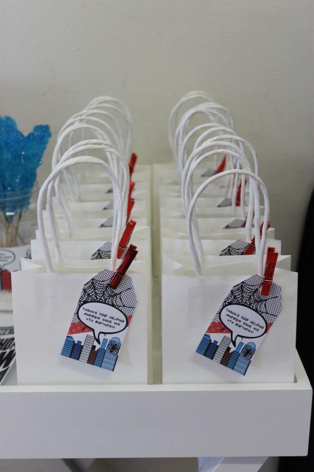 several small white bags with red and blue tags on them are sitting on a table