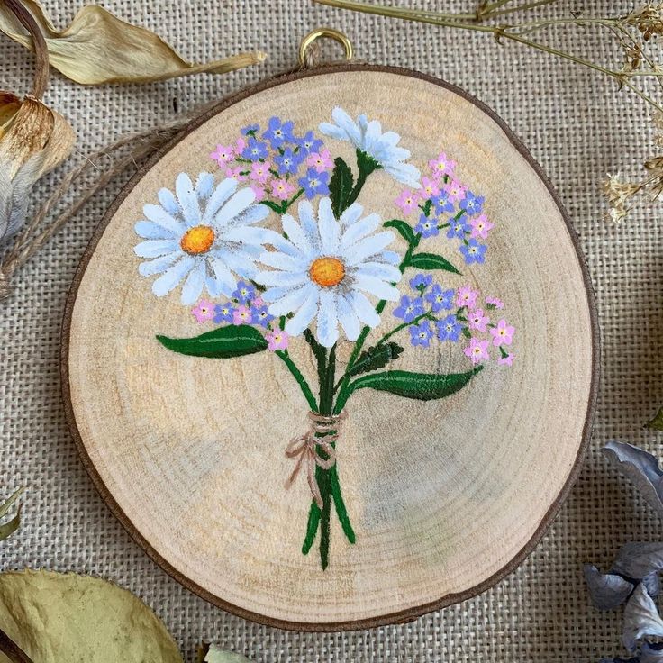 a wooden plate with flowers painted on it