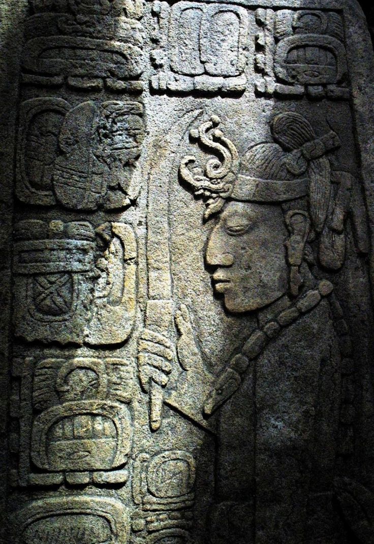 an ancient carving on the side of a stone wall with carvings and symbols around it