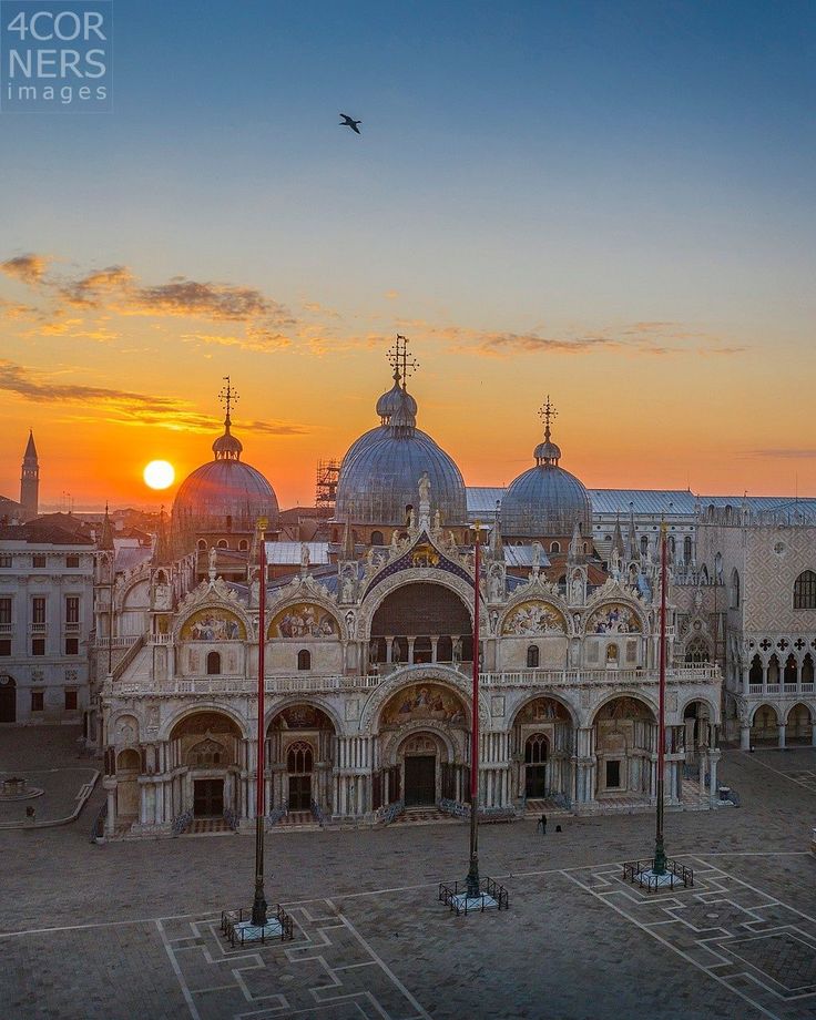 the sun is setting over an ornate building