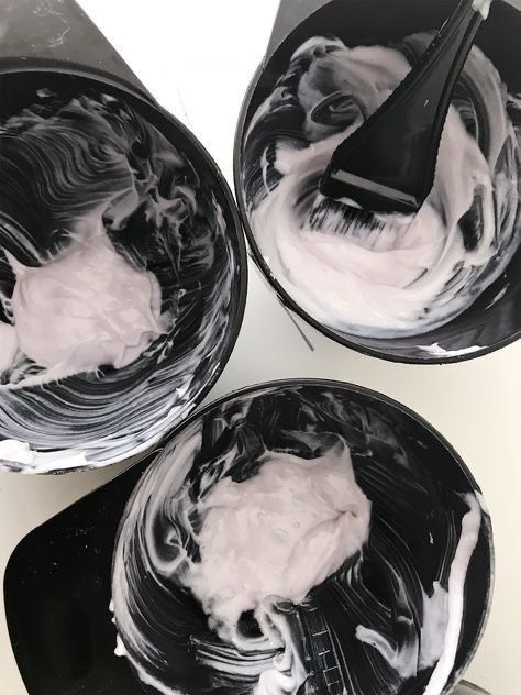 three black and white bowls filled with whipped cream