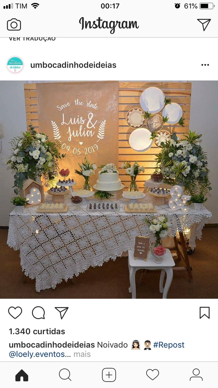 the table is decorated with white flowers and greenery for an elegant wedding reception at instagram