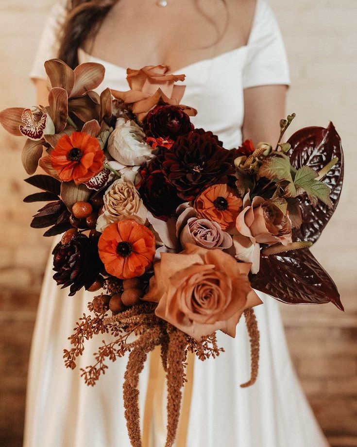 a woman holding a bouquet of flowers in her hands