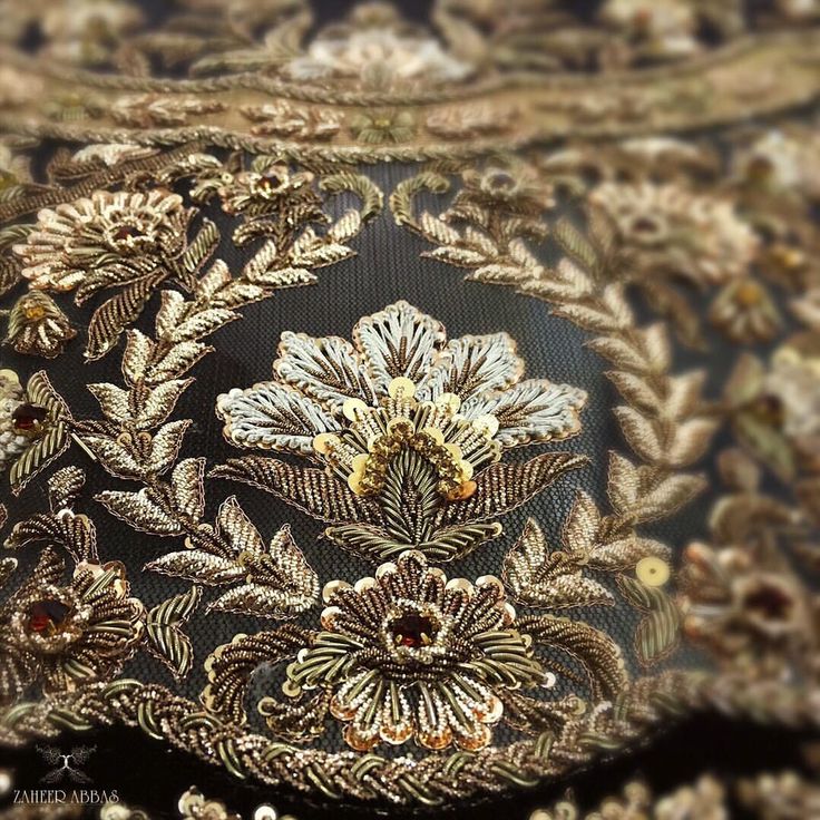 an intricately designed piece of cloth with gold thread and sequins