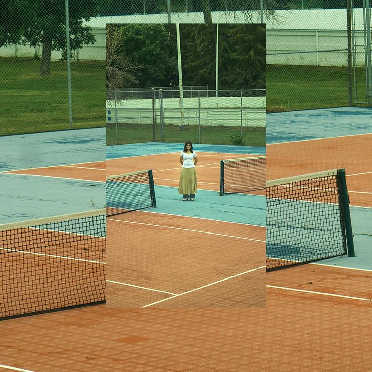 a woman standing on top of a tennis court holding a racquet