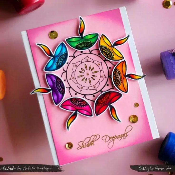 a pink card with colorful flowers on it