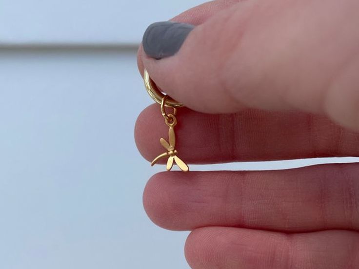 This tiny (gold plated) sterling silver dragonfly charm is handmade by our artisans in Thailand. As a spirit animal, the dragonfly is connected to the symbolism of change and light. When the dragonfly appears nearby, it may remind you to bring a bit more lightness and joy into your life. This cute and tiny charm features slightly cupped wings to make it appear as if it is mid-flight. All pendants fit our chains with a LINK closure. Bundle pendants or link your own for more ways to wear. Click he Adjustable Gold Dragonfly Jewelry, Handmade Gold Dragonfly Jewelry, Nickel-free Gold Dragonfly Jewelry, Tiny Charm, Dragonfly Charm, Jump Rings, Spirit Animal, Gold Plated Sterling Silver, Flight