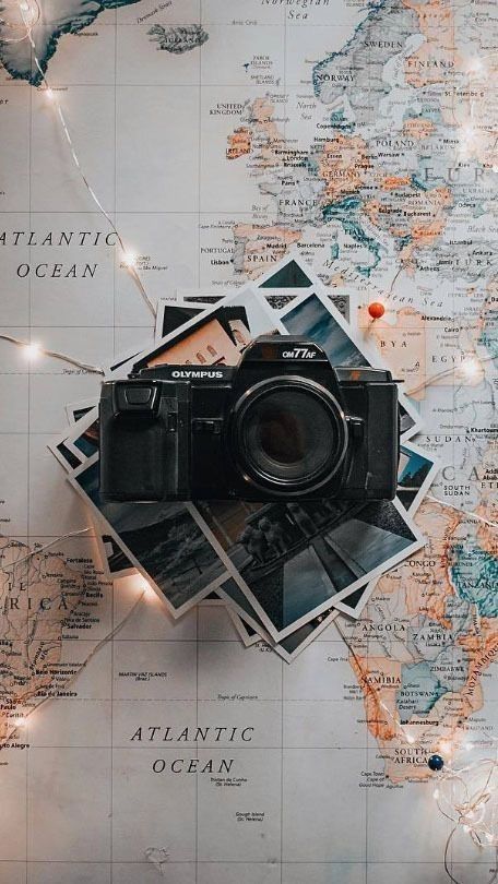 a camera sitting on top of a map with lights strung from it's sides