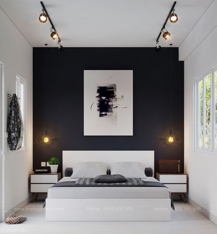 a bedroom with black walls and white furniture