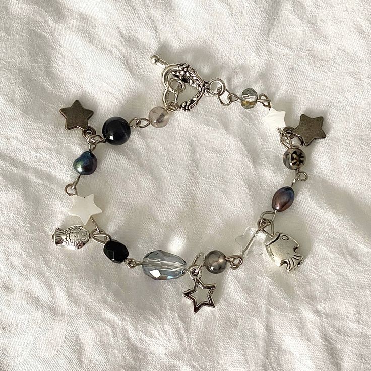 a silver bracelet with stars and beads