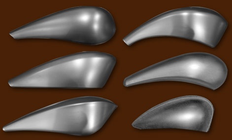 six different metal shapes on a brown background