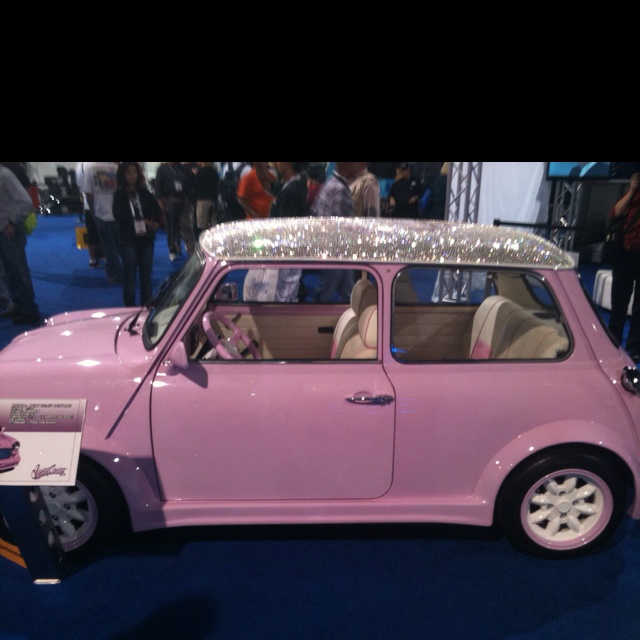 a small pink car with a shiny roof