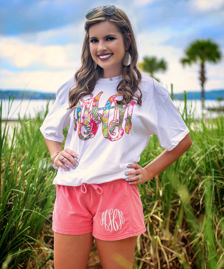 Our personalized graphic tees are so cute and make great personalized gifts! We are loving this tropical flower monogram design. Perfect for summer! Pair with jeans, our monogrammed shorts, or monogrammed leggings! The options are endless!  GILDAN Short Sleeve - 6.0 oz. pre-shrunk 100% cotton Long Sleeve - 6.0 oz. pre-shrunk 100% cotton V-Neck - 4.5 oz. pre-shrunk 100% ring spun cotton Tank Top - 5.3 oz. pre-shrunk 100% cotton Sweatshirt - 8 oz pre-shrunk 50% cotton/50% polyester   BELLA CANVAS Spring Casual T-shirt With Monogram Print, Summer Monogram Print T-shirt With Short Sleeves, Personalized Short Sleeve T-shirt For Spring, Monogram Print Short Sleeve Tops For Summer, Short Sleeve Tops With Monogram Print For Summer, Personalized Pink T-shirt For Summer, Casual Personalized Pink T-shirt, Personalized Casual T-shirt For Spring, Personalized Casual Spring T-shirt