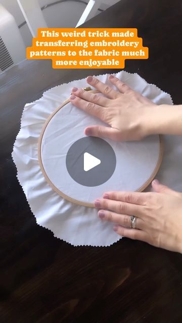 two hands on a table with a circular object in front of them that says, this weird trick made transfering embroidery onto paper to make more enjoyable