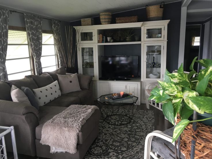 a living room filled with furniture and a flat screen tv on top of a wall